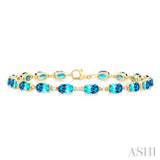 6X4 MM Oval Cut Blue Topaz and 1/6 ctw Round Cut Diamond Semi Precious Tennis Bracelet in 10K Yellow Gold