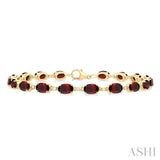 6X4 MM Oval Cut Garnet and 1/6 ctw Round Cut Diamond Semi Precious Tennis Bracelet in 10K Yellow Gold