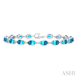 6X4 MM Oval Cut Blue Topaz and 1/6 ctw Round Cut Diamond Semi Precious Tennis Bracelet in 10K White Gold