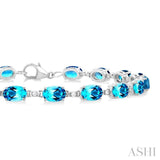 6X4 MM Oval Cut Blue Topaz and 1/6 ctw Round Cut Diamond Semi Precious Tennis Bracelet in 10K White Gold