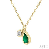 1/50 ctw Pear Cut 5X3MM Emerald and Bezel Set Round Cut Diamond Precious Necklace in 10K Yellow Gold